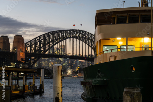 Sydney, Australia: A ferry waits in the downtown main Circular Quay pier with the famous Sydney Harbour Bridge in the background in Australia