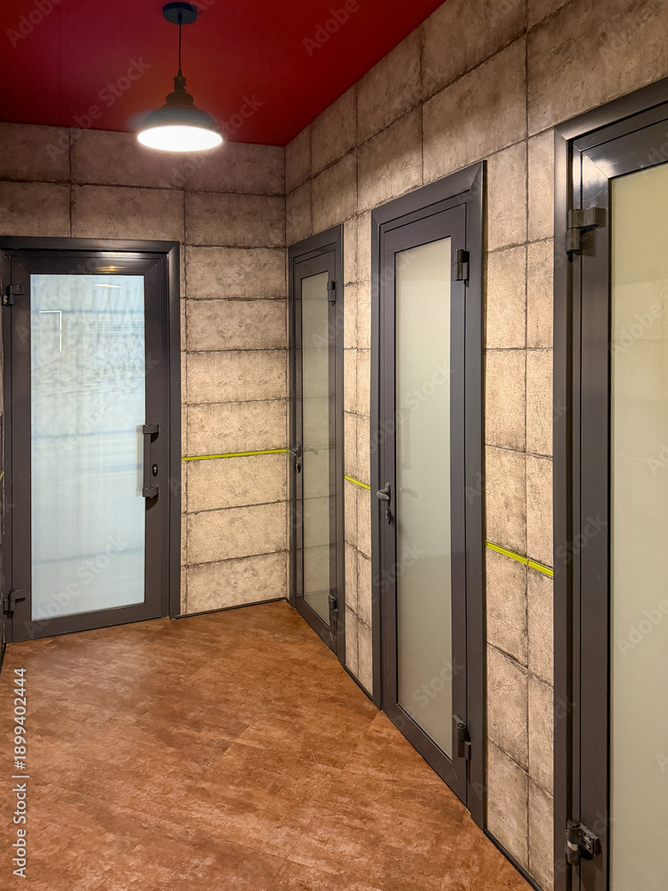 Fototapeta premium A hallway with a door on the left and two doors on the right