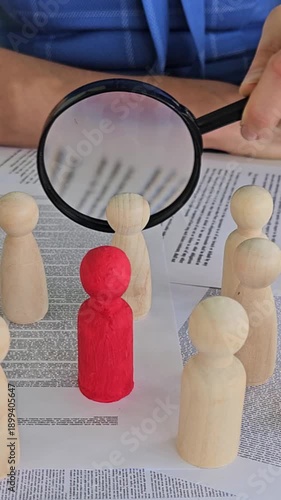 Wallpaper Mural Exploring group dynamics with wooden figures and a magnifying glass in a study setting Torontodigital.ca