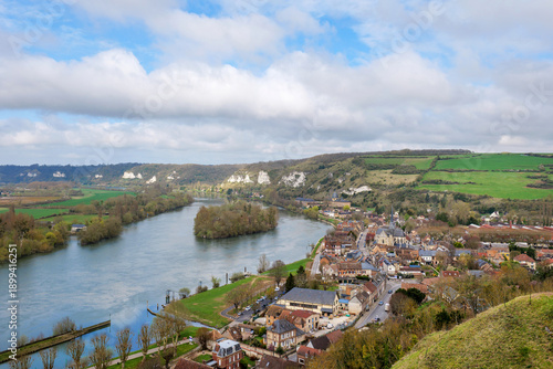 Scenic view of Les Andelys village in France from Chateau Gaillard, early spring with fresh greenery, historic buildings and river visible, village showcasing French countryside charm