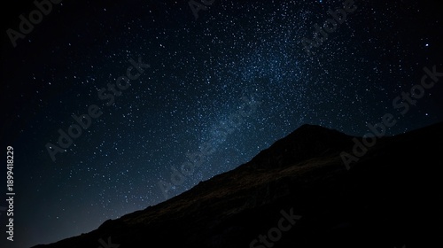 milkyway. A stunning view of the night sky filled with stars and the Milky Way, framed by mountain silhouettes. travel magazines, destination branding, designed for travel destination branding.