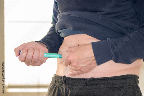 Man Performing Self Injection Abdomen