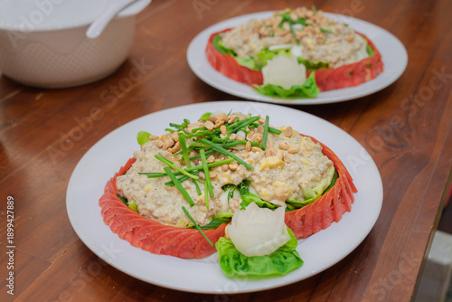 Traditional Lao minced meat salad served in carved watermelon bowl.