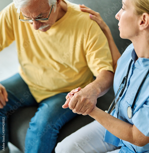 Wallpaper Mural Doctor or nurse caregiver's hand giving support to sad lonely senior man at home or nursing home Torontodigital.ca