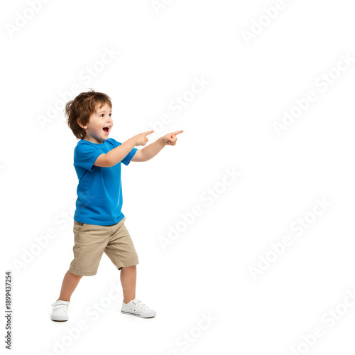 Curious little boy pointing his finger at empty copy space, surprised child showing something interesting, discovery and childhood wonder concept