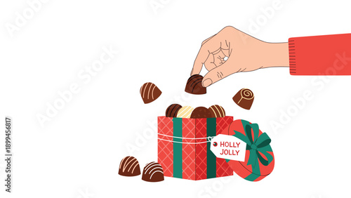 Hand reaches out to take a delicious chocolate truffle from a festive red and green holiday gift box labeled with holly jolly text.