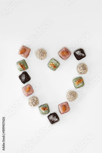 Minimalist flat lay of handmade chocolates with heart-shaped plate.