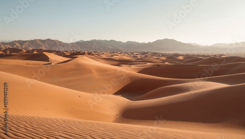 Wide View of Sand Dunes Under the Sun With Foothills in the Background During...