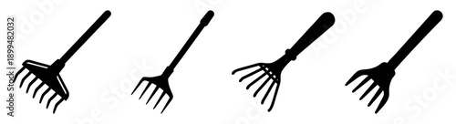 Set of four black garden rakes isolated on white background for yard work and landscaping tools