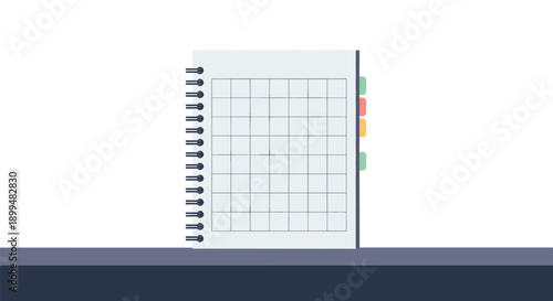 Minimalist notebook with grid pages and colorful tabs on desk