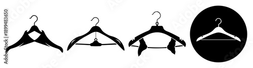 Set of three empty black coat hangers on white background minimalist flat lay clothing storage