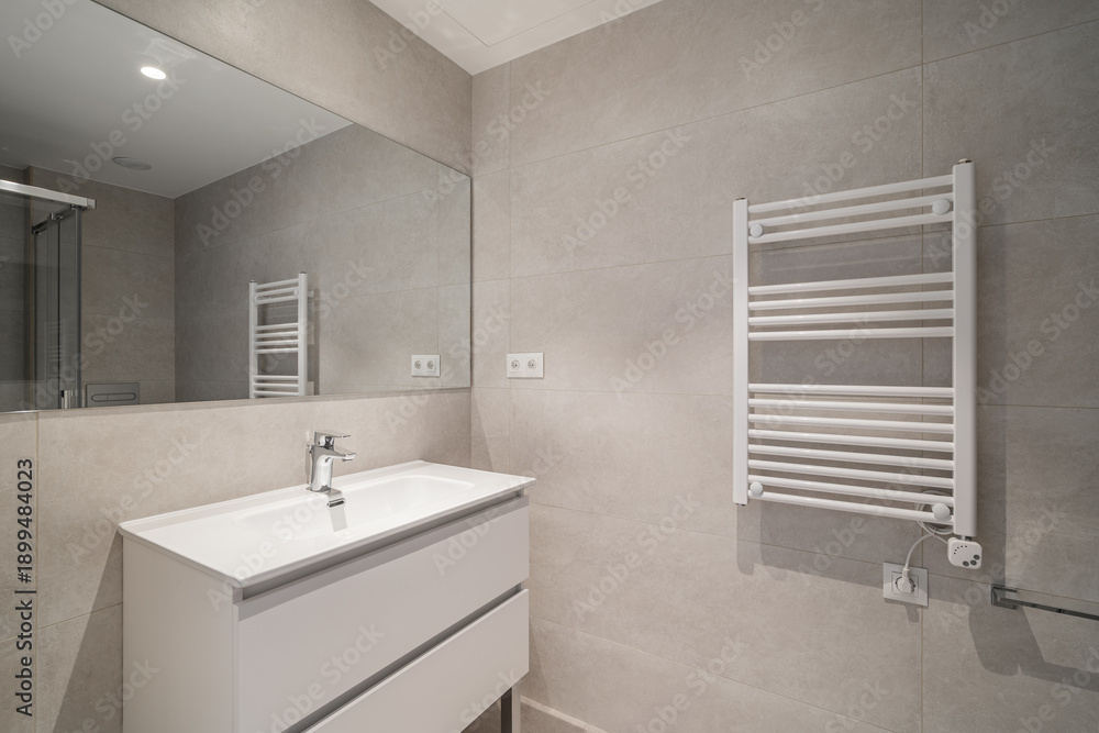 custom made wallpaper toronto digitalModern bathroom with gray tiles, a white sink cabinet, and a towel radiator. The space is well-lit and features a large mirror.