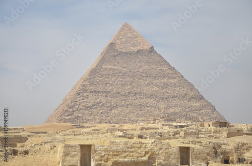 The pyramid of Khafre or of Chephren in the middle of the three Ancient Egyptian Pyramids of Giza,with remnants of the original limestone lining