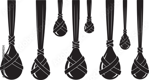 Tied spoons hanging in a row on white background