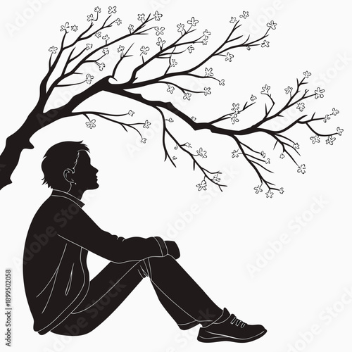 A contemplative silhouette of a person sitting beneath a barren tree branch.