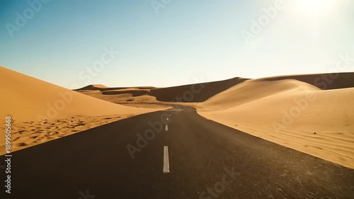Desert Road with Sand Dunes and Clear Sky.