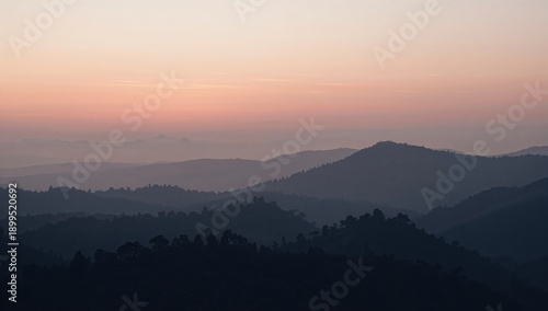 Sunset Over Mountains With Layers of Hills and Valleys in the Background