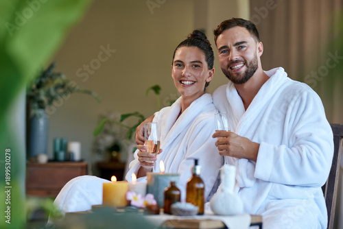 Portrait of loving couple drinking wine at spa