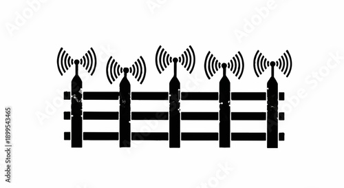 Wireless communication towers broadcasting signals over a fence