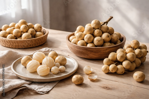 Exotic Lansium Parasiticum Arrangement: A captivating arrangement of fresh Lansium parasiticum, showcasing the fruit in various stages from whole to peeled. Captured in a studio setting.