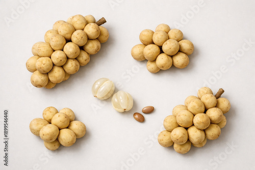 Fresh Langsat Arrangement: Exquisite arrangement of fresh langsat fruit, showcasing its unique texture and inviting appearance. A tempting food composition perfect for culinary enthusiasts.