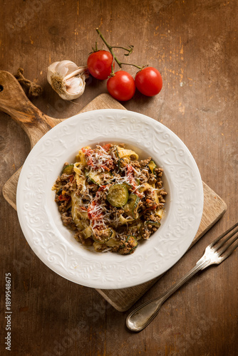 Tagliatelle with white ragout zucchinis and tomatoes