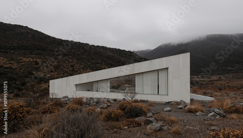 Modern Building Stands Alone on Rocky Landscape Under Cloudy Sky in Rural Area