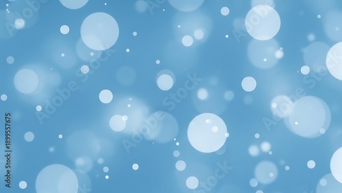 Light blue background with white bokeh circles of various sizes bokeh effect