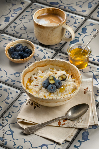 Morning breakfast. Honey-creamy rice porridge with blueberries and almond pieces.
Kitchen still life.