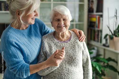 Elderly woman with her caregiver in a nursing home
