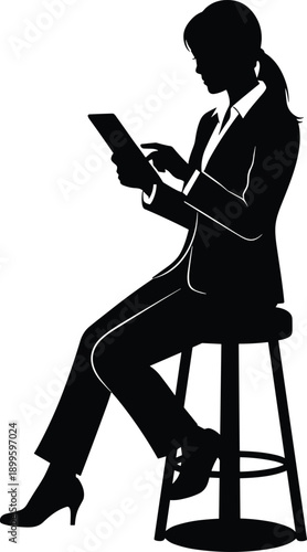 Businesswoman using tablet while sitting on stool