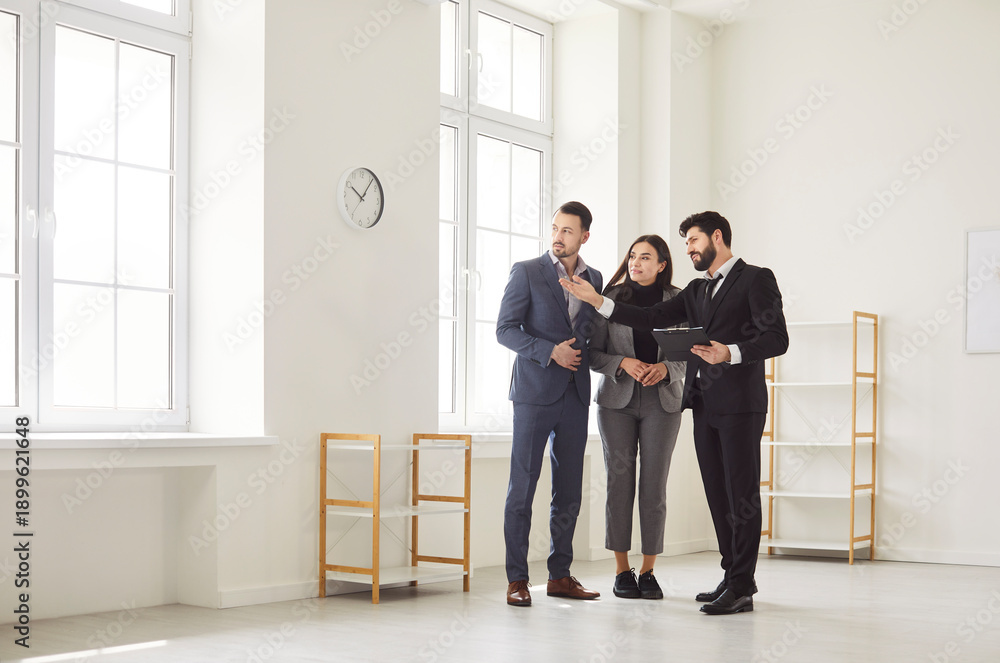 Fototapeta premium Agent, architect or interior designer showing new apartment plan to couple at meeting, realtor consulting customers making real estate offer, mortgage loan investment, office repair planning