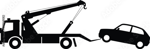 Tow truck lifting a car on a busy city street during a sunny day.