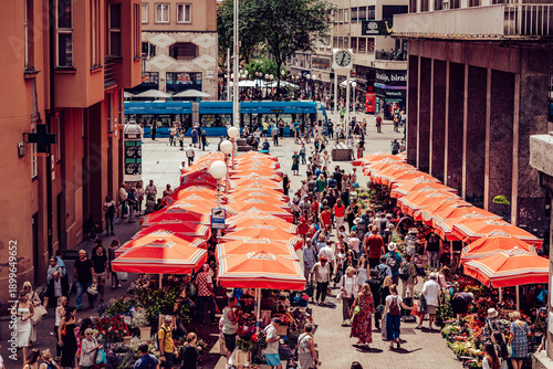 Wallpaper Mural Zagreb, Croatia - 15 June 2024: View of the vibrant Dolac Market, a river of red umbrellas flowing through the heart of the city, bustling with shoppers under the warm summer sun. Torontodigital.ca