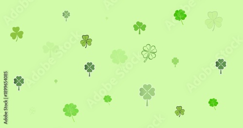 Digital animation of multiple clover leaves forming against green background