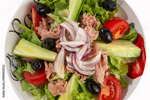 Salad with ham, tomatoes, eggs, olives, yellow cheese and onion