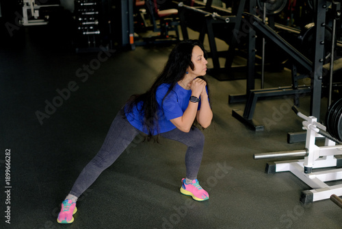 Woman warming up before workout in gym