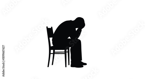 Silhouette of a person slumped in a chair conveying sadness or despair