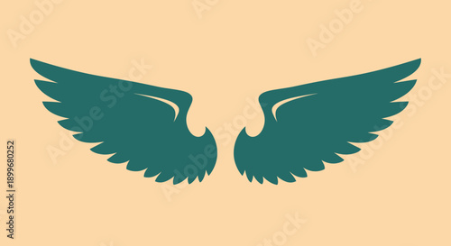 Pair of green wings on a beige background, symbolizing freedom and flight.