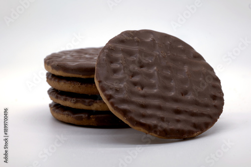 close-up of a chocolate digestive biscuit stack, baked wheat base with rich chocolate coating, a quintessential British treat perfect for dunking in tea or enjoying as a crunchy, indulgent snack