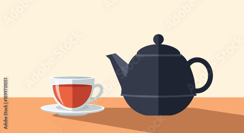 A dark teapot and a glass cup filled with amber liquid on a table