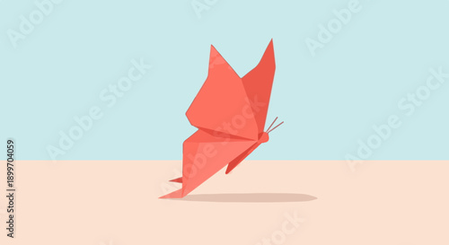 A coral origami butterfly casts a shadow on a light peach surface