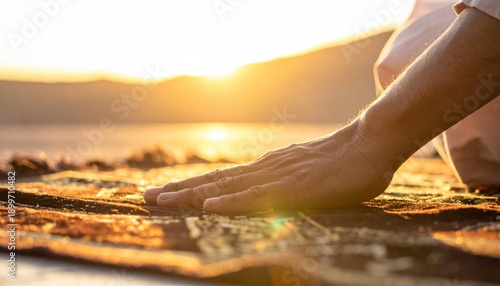 Wallpaper Mural Man's Hand Resting on Prayer Rug During Golden Hour Sunset with Mountain Landscape Silhouette Calm Serene Atmosphere Warm Golden Light Torontodigital.ca