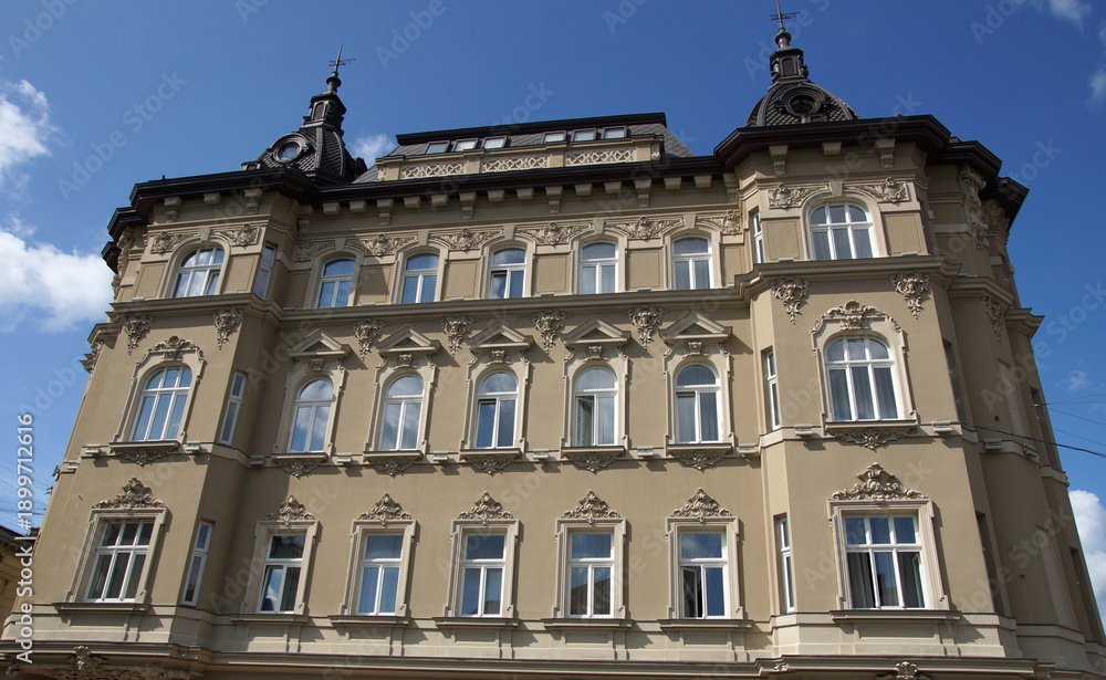 Fototapeta premium Historical Building Facade in Lviv with Grey Stone Exterior and Characteristic European Windows