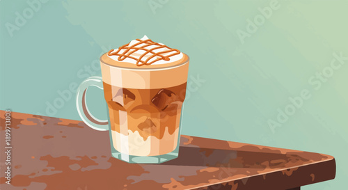 A tall glass of iced coffee with whipped cream and caramel drizzle sits on a wooden surface