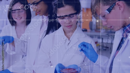 In this image, we see school children doing a chemical experiment in a laboratory