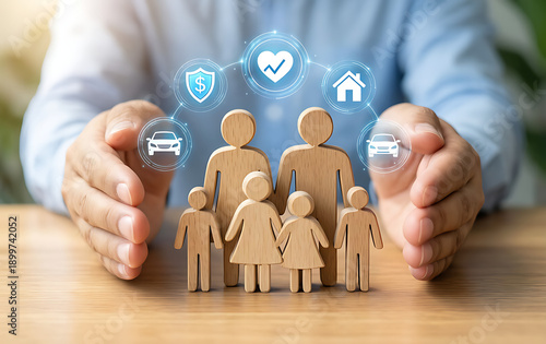 Hands protecting wooden family figures with insurance