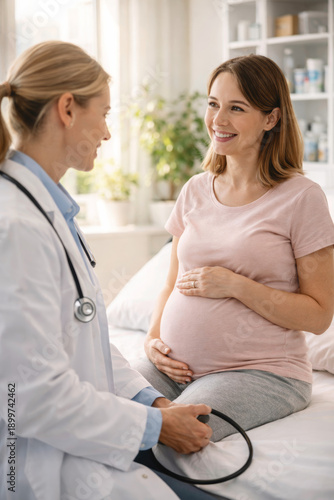 Pregnant woman smiling during a check-up with her doctor