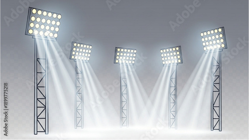 Four tall metal light towers with bright spotlights shining down intensely on a stage from various angles