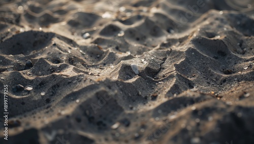 Waves of Sand Create Patterns in a Dry Desert Landscape at Sunset With Warm L...